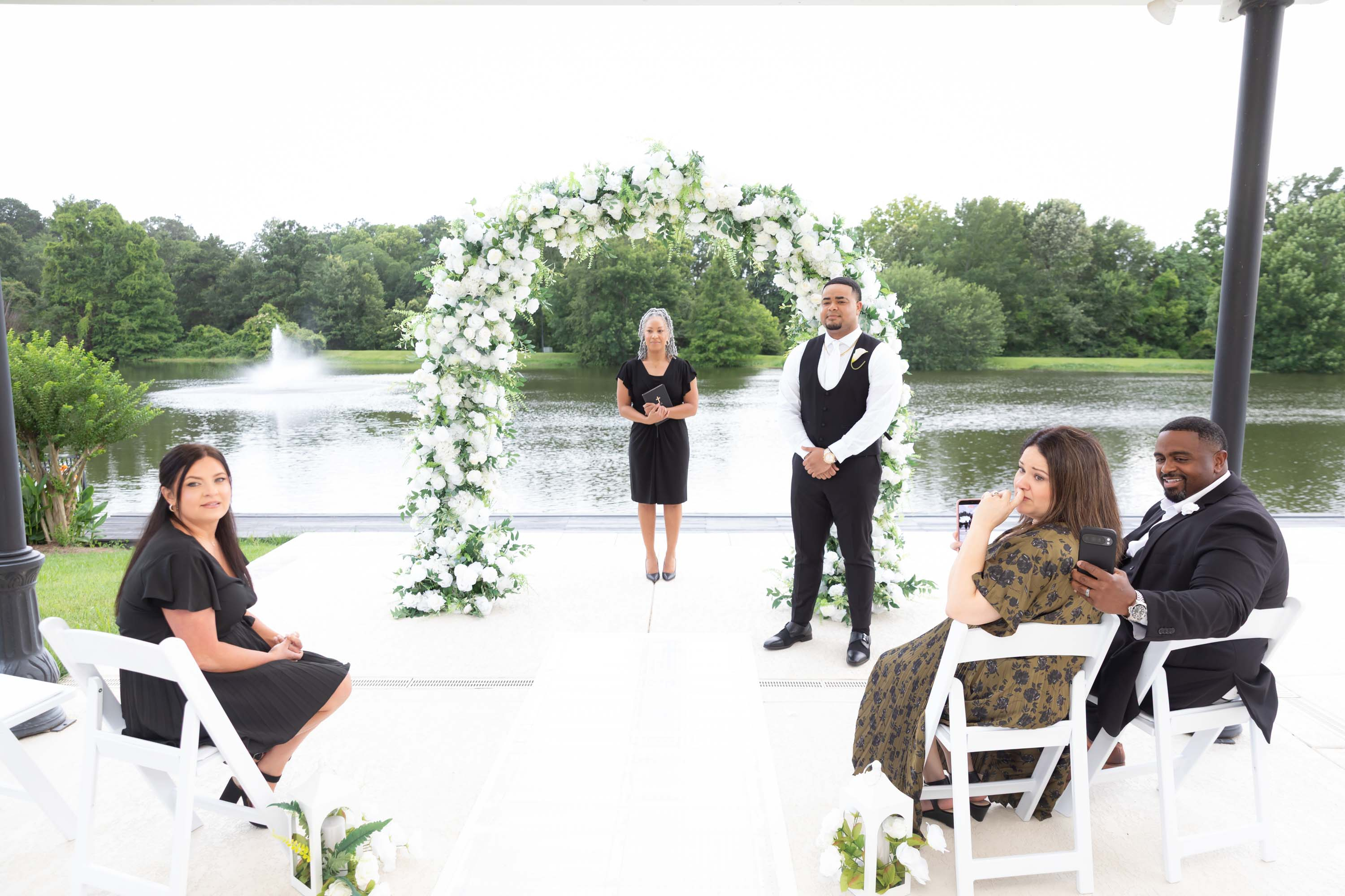 Intimate Nano Nuptials ceremony seating, aisle, floral arch and lake view