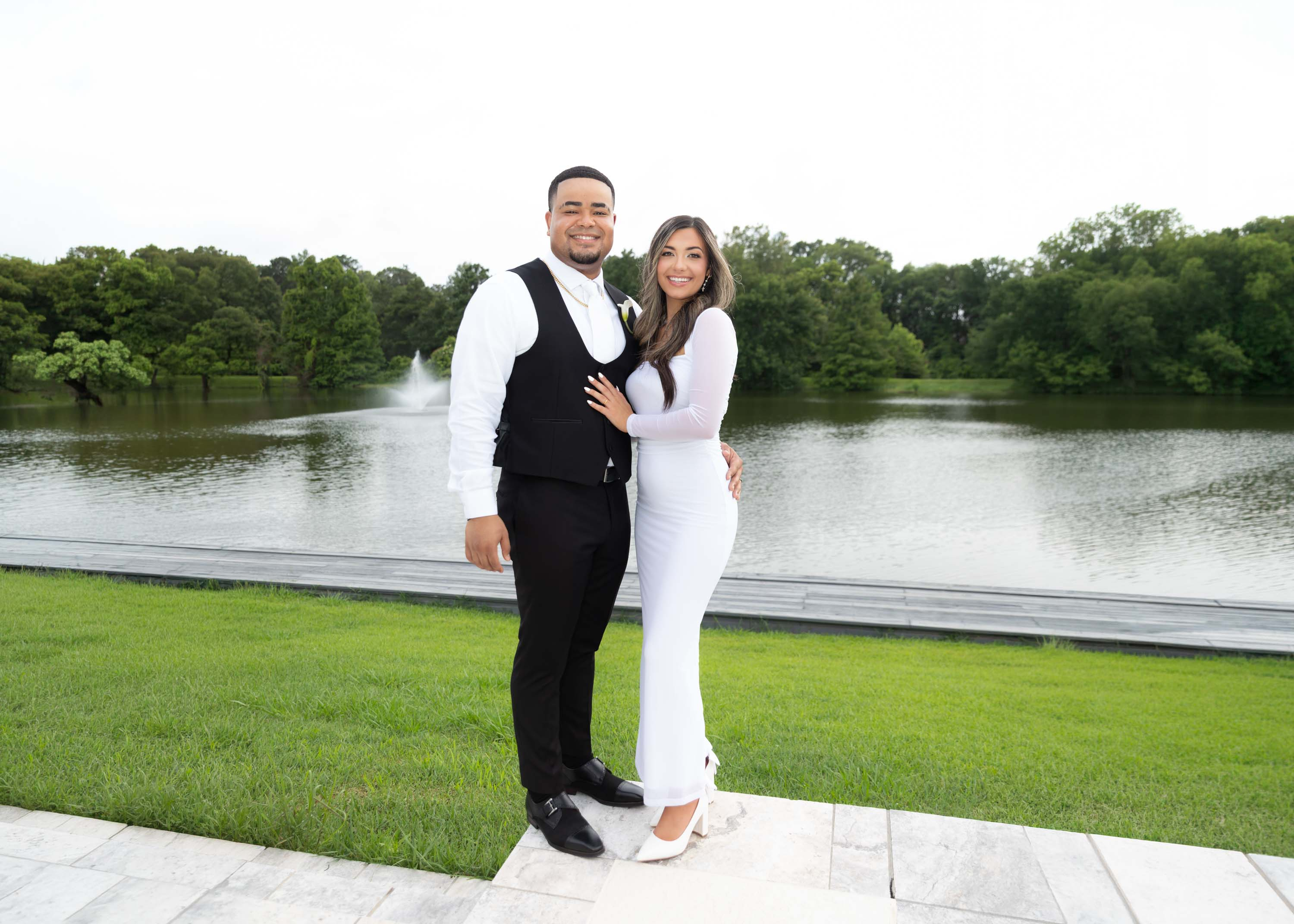 Nano Nuptials couple posing beside the lake