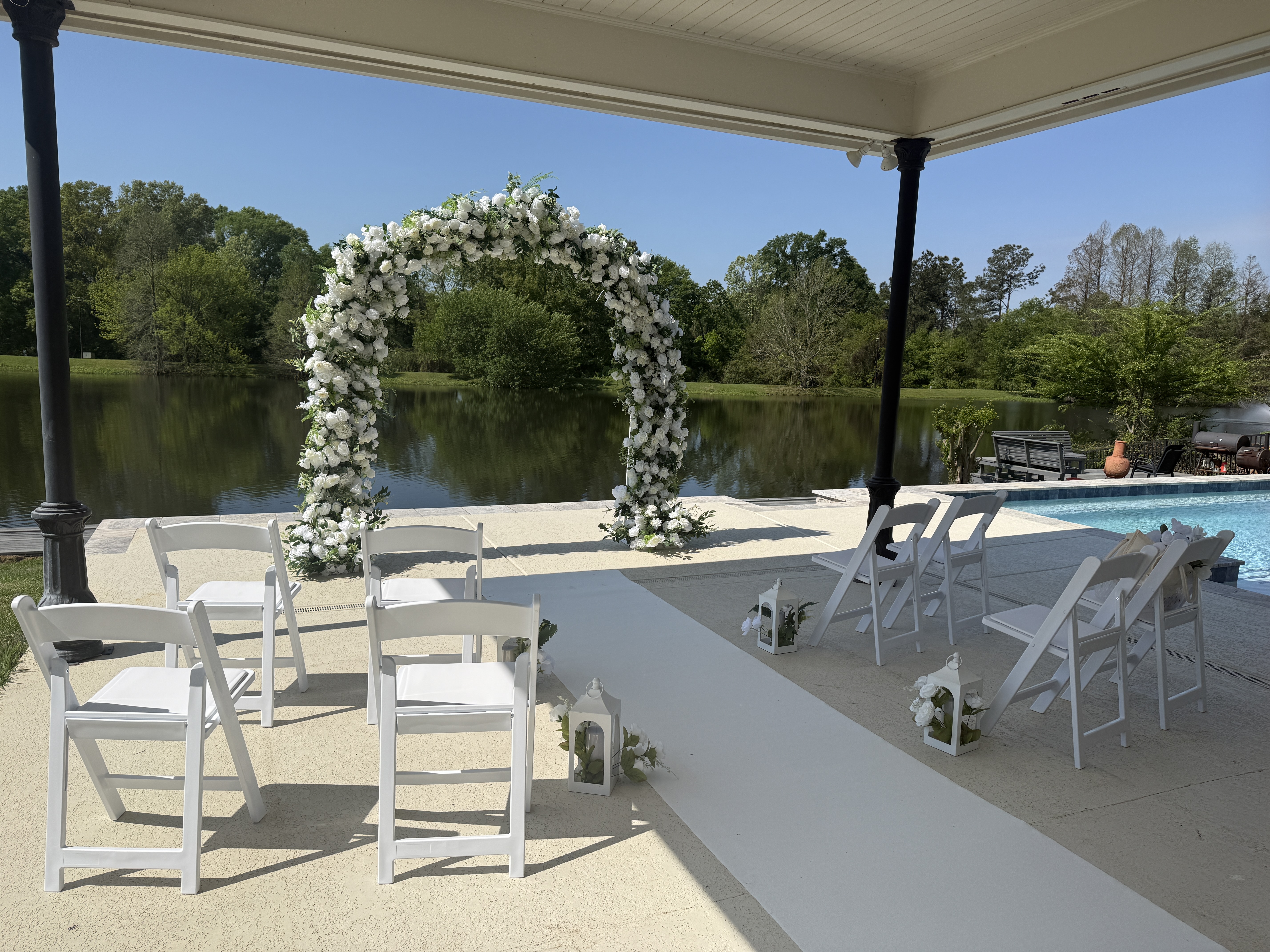 Nano Nuptials wedding ceremony setup with arch, chairs and lake view